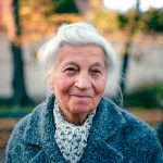 An old woman is walking down the street